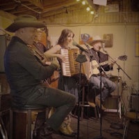 a group of people playing music in a bar